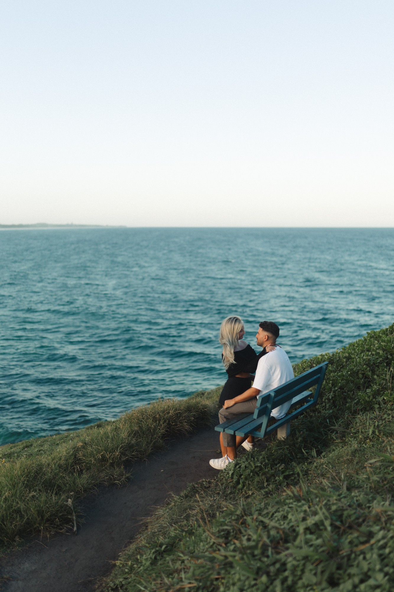 Sarah and Alex on a bench above the sea